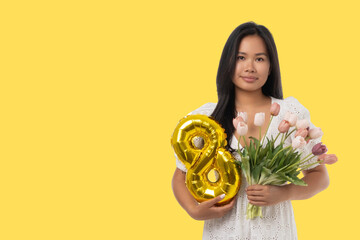 Obraz premium A young woman holds a bouquet of flowers and a number 8