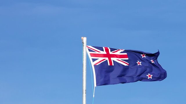 New Zealand National Flag Waving Against a Clear Blue Sky