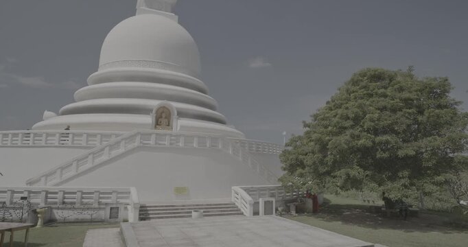 Sri Lanka, Unawatuna. Japanese Peace Temple In Rumassala, Galle, Sri Lanka. Monks walking around Famous landmark and cultural sacred place. View of the Japanese built Buddhist Temple Peace Pagoda at