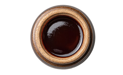 Overhead view of dark brown sauce in a round, earthenware bowl