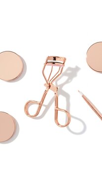 Makeup brush and eyelash curler tools.