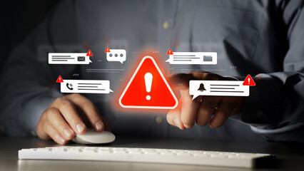 The businessman's hand is touching a virtual alert icon about threats from scams, viruses, and...
