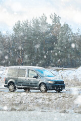 Fototapeta premium Commercial passenger van in snowy landscape