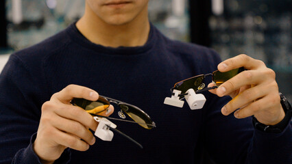 Fototapeta premium Close up of man holding different eyewear frames