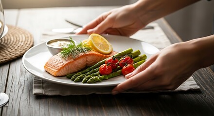 Hands Presenting a Plate of Seared Salmon with Fresh Asparagus Meal