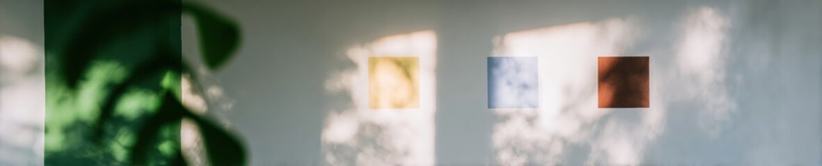 Minimalist Wall Background with Dappled Sunlight and Blurred Foliage Shadows Featuring Small Geometric Accents for Branding Mockup and Creative Presentation Space