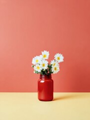 Bouquet of white daisies in a red glass vase sitting on a yellow table against a coral background for mother day or birthday celebration greeting card copy space