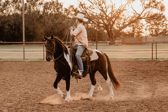 cowboy riding his horse in the summertime