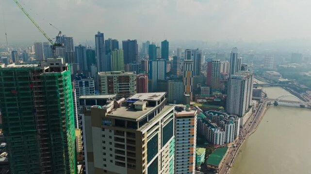 Binondo district with modern high rises and the calm Pasig River in Manila