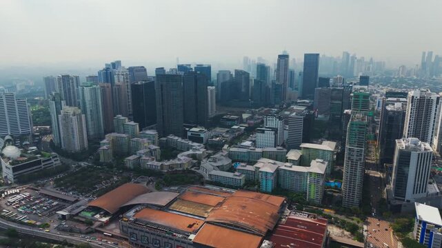 Slow panoramic camera movement shows dense skyline and market rooftops, BGC
