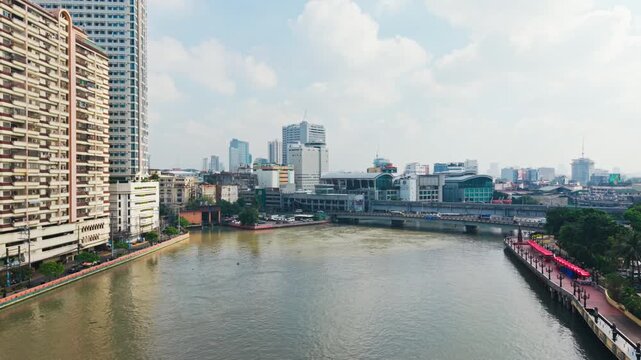 Pasig River with Binondo buildings and calm water reflecting sunny Manila
