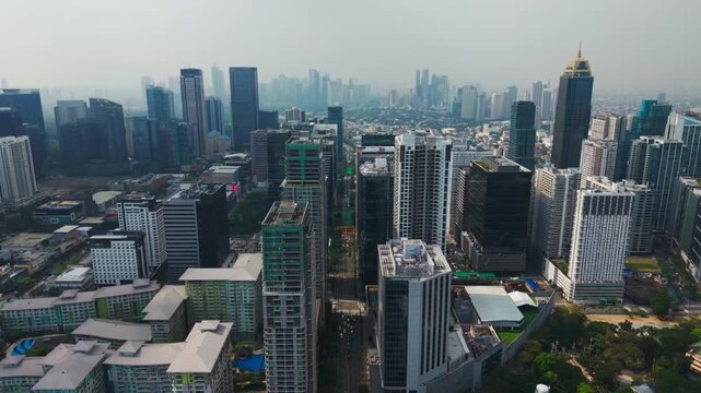 Cinematic aerial shows Bonifacio Global City skyline and morning traffic