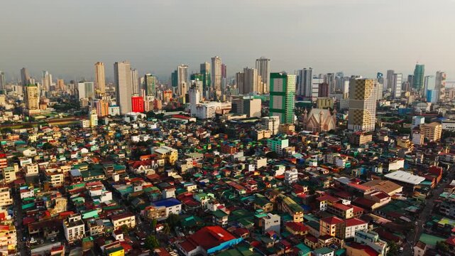 Dramatic drone ascent revealing contrast between Tondo slums and Manila towers