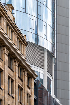 Stone heritage facade meets modern glass skyscraper in urban frankfurt germany showing architecture contrast and detailed city exterior textures