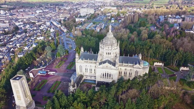 Aerial view of the Basilique Sainte Th&eacute;r&egrave;se in Lisieux city, Calvados county, Normandy region, showing the monumental sanctuary surrounded by wooded park, pilgrimage gardens and historic district.