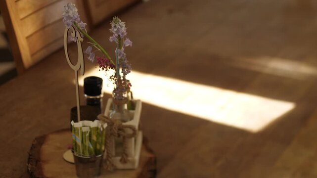 Sunlight stretches across hardwood tabel with flowers