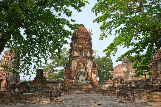 Large brick prang and Buddha statue at Wat Mahathat ruins