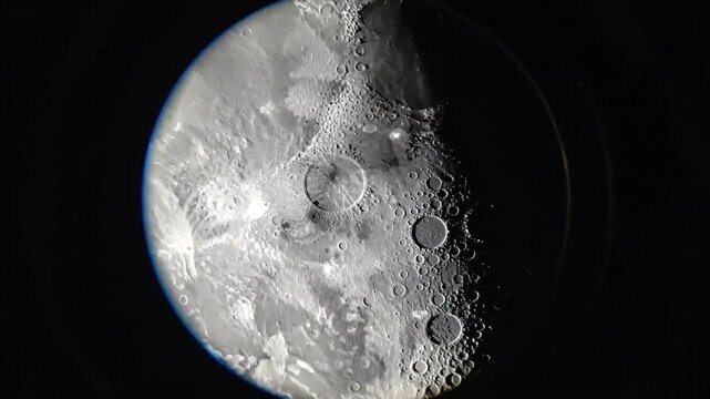 Close-up of the moon showing craters and terminator