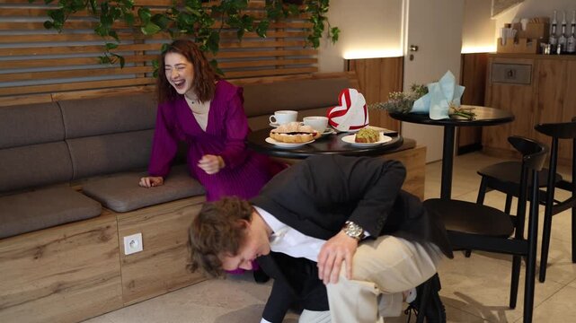 Young couple covers faces during awkward moment in cafe emotional tension on romantic date misunderstanding stress and failed Valentine style meeting with gifts and coffee on table