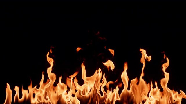 Slow motion flames dancing against a deep black background, creating a dramatic and powerful fire effect. Abstract burning fire with glowing orange and yellow tongues of flame, ideal for backgrounds, 