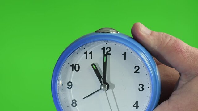 Spring forward Daylight Saving Time change showing clock adjustment and green screen background