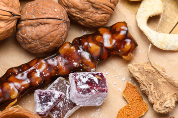 Close-up of walnut churchkhela and Turkish delight cubes with festive decorations.