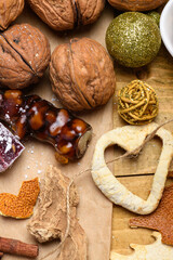 Churchkhela with walnuts and festive Christmas decorations on wooden table