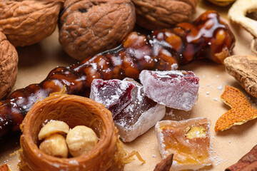 Churchkhela with walnuts and Turkish delight on festive background