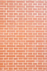 Obraz premium Red brick wall with uniform pattern, showcasing a classic masonry design, ideal for backgrounds in architectural and construction-related projects