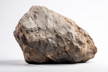 Obraz premium Large rock isolated on a white background, displaying rough texture and natural colors