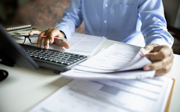 asian businessman, legal expert, professional lawyer working on desk with computer reviewing document and business contract before provide legal advice to clients