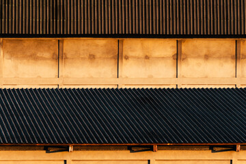 cement building with brown roof with sunlight morning