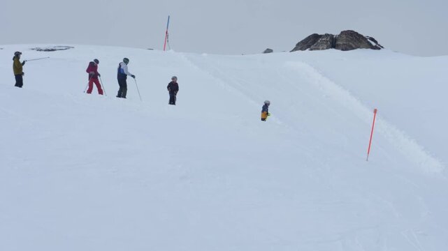 Ski instructor teaching a group of children in davos klosters