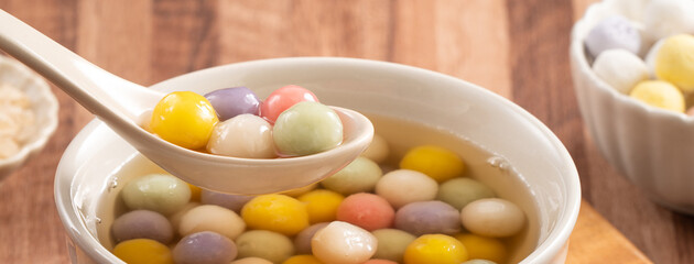 Colorful sweet glutinous rice balls tangyuan in sweet ginger syrup soup