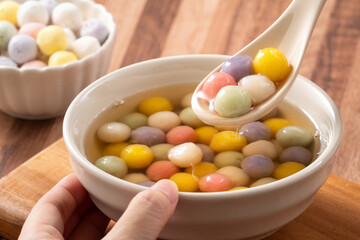 Colorful sweet glutinous rice balls tangyuan in sweet ginger syrup soup