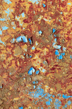 Weathered metal with rust and remnants of blue paint