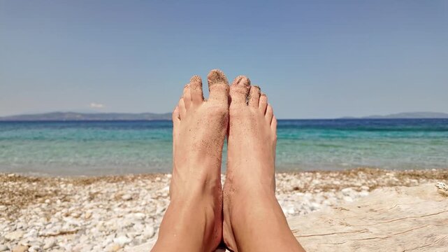 Man sunbathing on a rocky sea ocean beach.