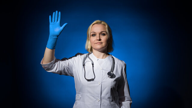 woman doctor waving greeting from the dark