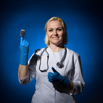 female doctor demonstrates a pulse meter on her finger. coronavirus concept