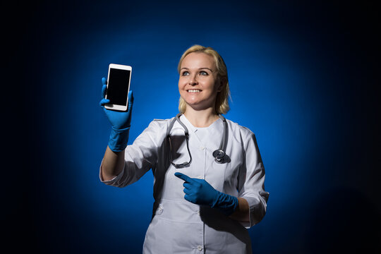 a female doctor demonstrates a smartphone and looks away. blank for designers