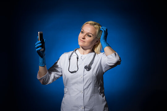 a female doctor looks at a smartphone and scratches her head. concept to take or not to take