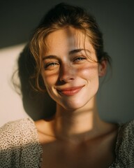 Smiling young woman portrait in warm natural sunlight with soft shadows