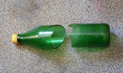 A green glass bottle divided into two halves