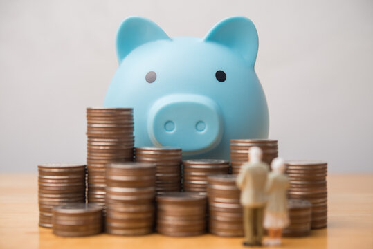 Senior couple looking at piggy bank heap coins. IRA individual retirement account, money financial risk management, pension, savings planning, deposit account for elder or retirees and so on concept.
