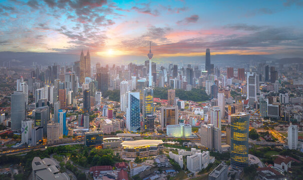 An aerial view of the Kuala Lumpur city Malaysia,  Modern buildings and street traffic.Kuala Lumpur city skyline with dramatic sky , twilight scene . Malaysia .	
