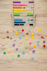 Fun math background. Composition of colorful, wooden numbers and soft bubbles.