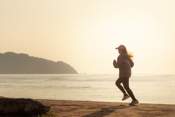 Woman Running by the Sea at Sunrise Healthy Lifestyle