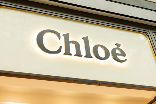 Singapore - January 27, 2026: The store sign of Chloe is lit up in a shopping area in Singapore. Shoppers are moving around and looking at various shops in the afternoon. The area is busy and lively