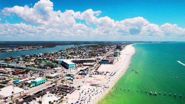 Static drone aerial shot over Fort Myers Beach and Estero Island on 18 August 2024, bird&rsquo;s-eye view of sandy shoreline, turquoise ocean, and sunny coastal landscape in Florida