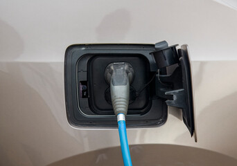 charging cable that is connected to the charging port of an electric car